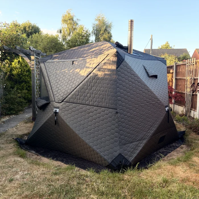 The wood-fired sauna tent in golden evening light