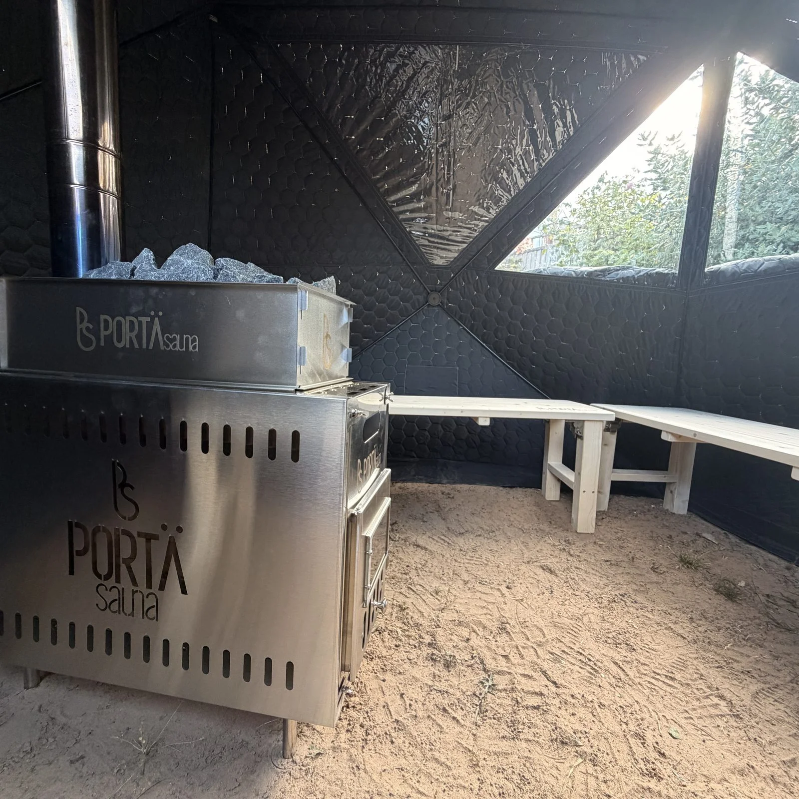 Inside the sauna — wood-fired stove and bench seating