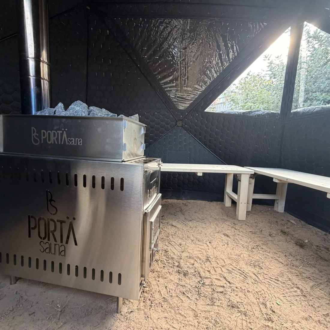 Inside the sauna — wood-fired stove and bench seating